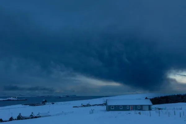 Dark clouds over a snowy landscape